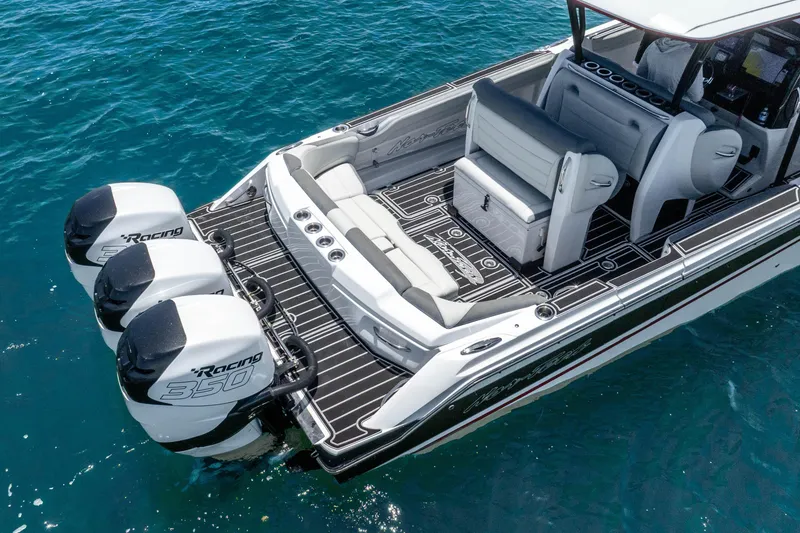 Slide: The Image of 2019 Nor-Tech 390 Sport Center Console boat with triple Racing 350 engines on blue water. - 11