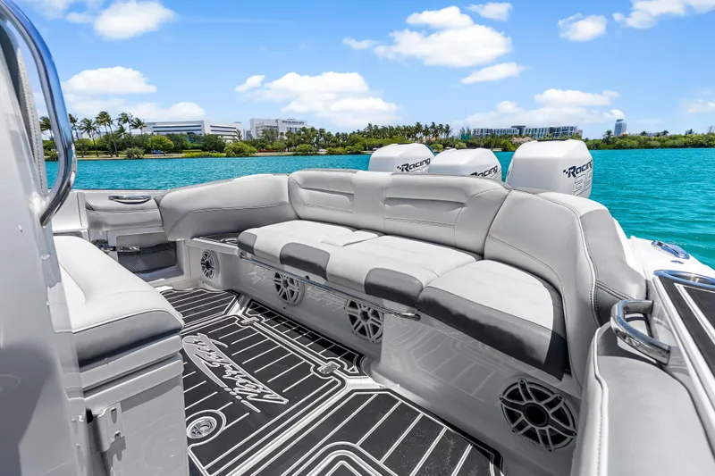 Slide: The Image of 2019 Nor-Tech 390 Sport Center Console boat with luxurious seating on a sunny day. - 12