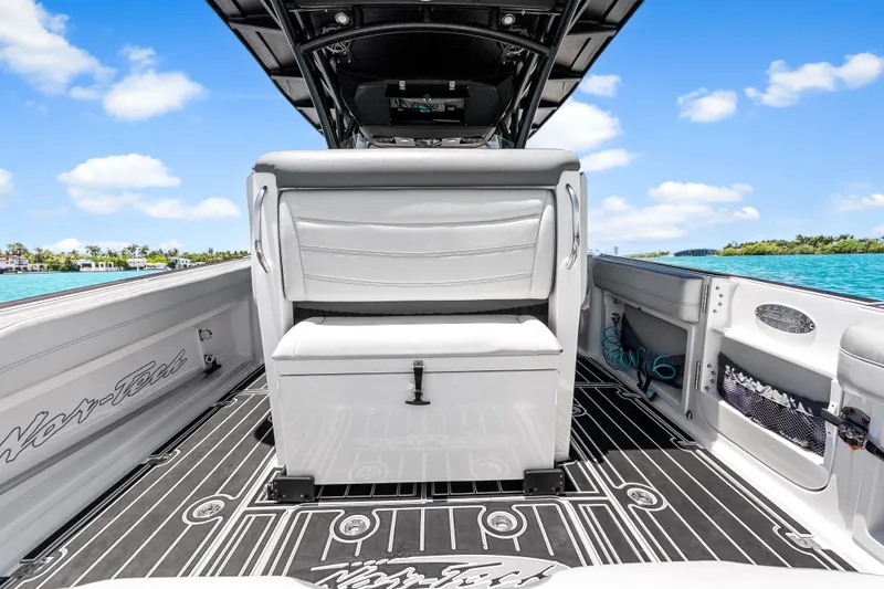 Slide: The Image of 2019 Nor-Tech 390 Sport Center Console boat interior with sleek seating and ocean view. - 15