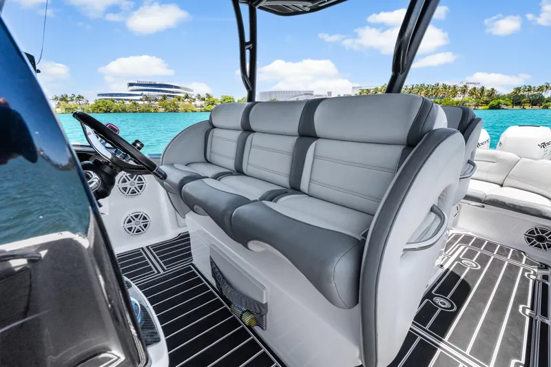 Slide: The Image of 2019 Nor-Tech 390 Sport Center Console boat interior with luxurious seating and scenic waterfront view. - 18