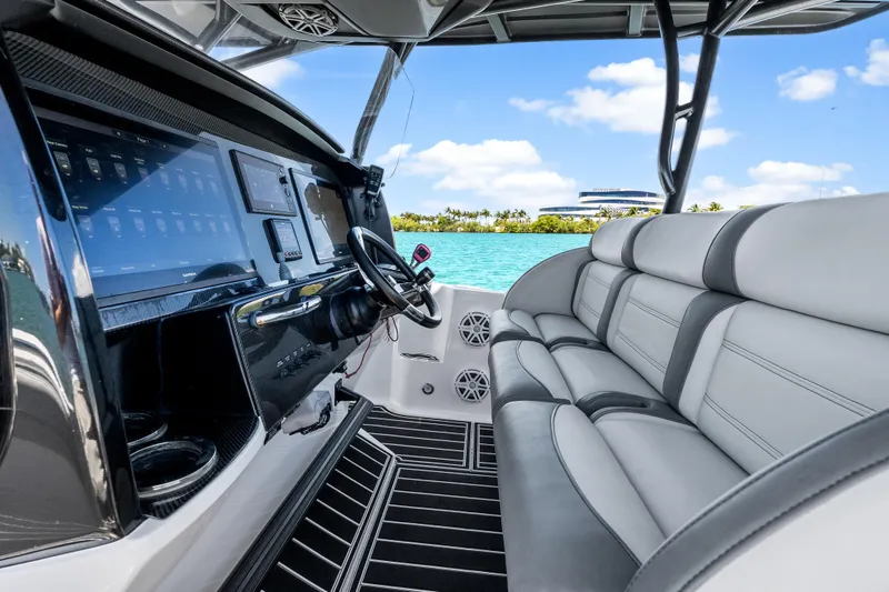 Slide: The Image of 2019 Nor-Tech 390 Sport Center Console interior with sleek dashboard and comfortable seating. - 19