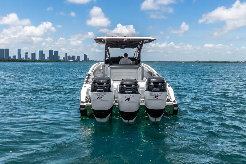 Slide: The Image of 2019 Nor-Tech 390 Sport Center Console boat with triple 350R engines on open water. - 2