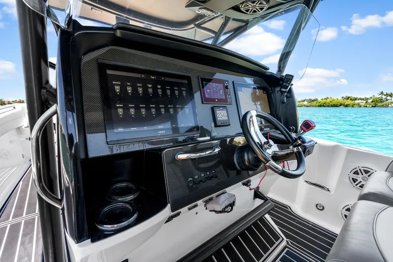Slide: The Image of 2019 Nor-Tech 390 Sport Center Console dashboard with advanced navigation and control systems. - 21
