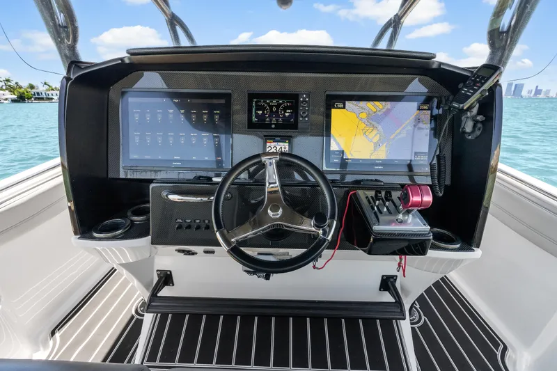 Slide: The Image of 2019 Nor-Tech 390 Sport Center Console dashboard with navigation screens and steering wheel. - 22
