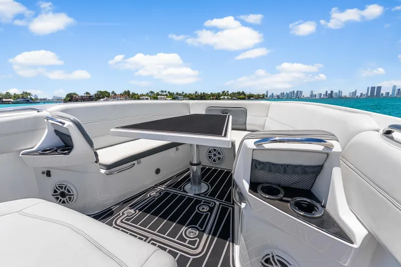 Slide: The Image of Luxurious 2019 Nor-Tech 390 Sport Center Console boat interior with seating and table, ocean view. - 24