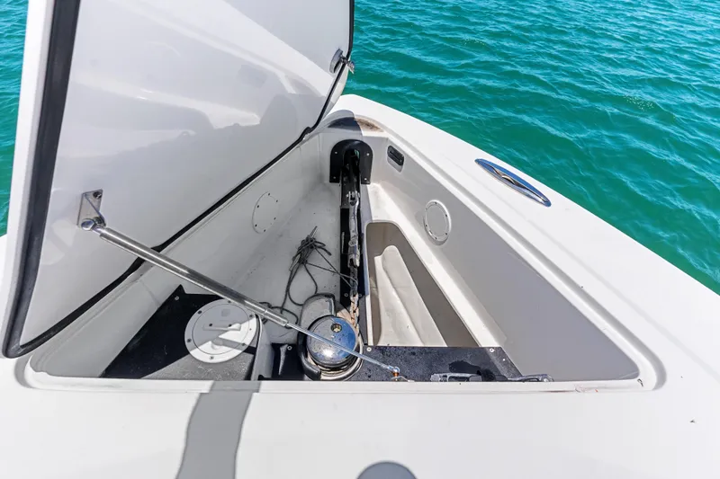 Slide: The Image of Open anchor compartment on 2019 Nor-Tech 390 Sport Center Console boat, with ocean background. - 26