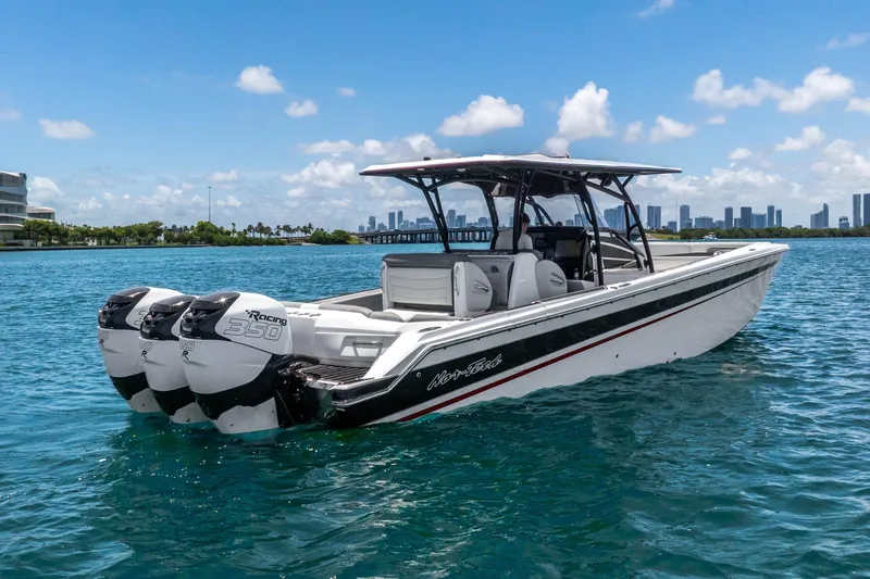 Slide: The Image of 2019 Nor-Tech 390 Sport Center Console boat on blue water, city skyline in background. - 3