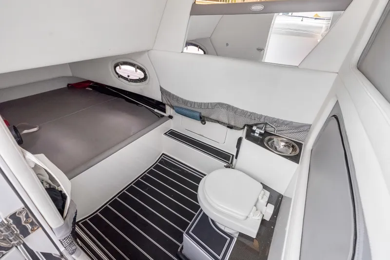 Slide: The Image of 2019 Nor-Tech 390 Sport Center Console cabin with bed, toilet, and sink. - 31
