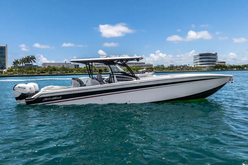 Slide: The Image of 2019 Nor-Tech 390 Sport Center Console boat on clear blue water, sunny day. - 4