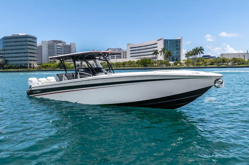 Slide: The Image of 2019 Nor-Tech 390 Sport Center Console boat on water, cityscape background. - 5