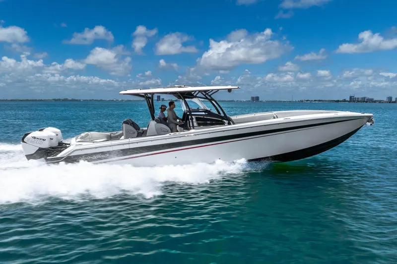 Slide: The Image of 2019 Nor-Tech 390 Sport Center Console cruising on clear blue water. - 6