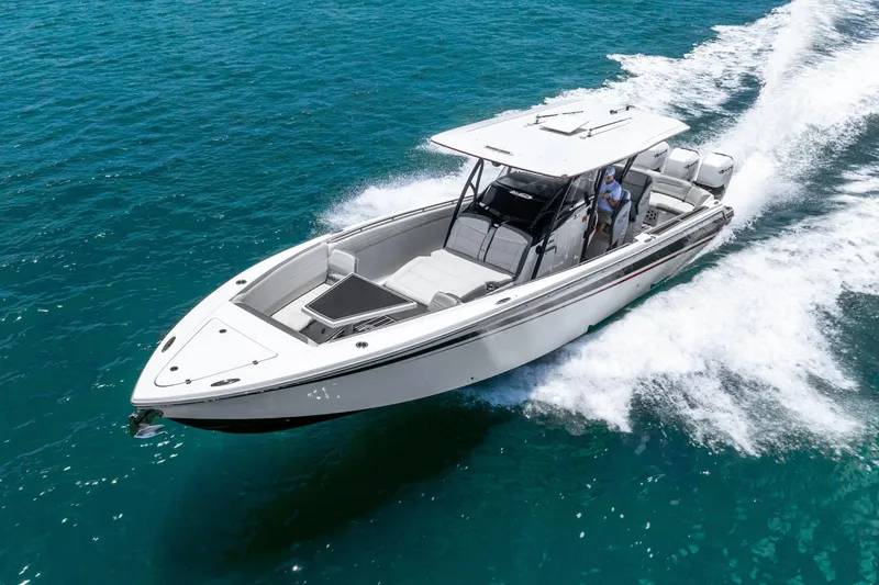 Slide: The Image of 2019 Nor-Tech 390 Sport Center Console cruising on clear blue water. - 7