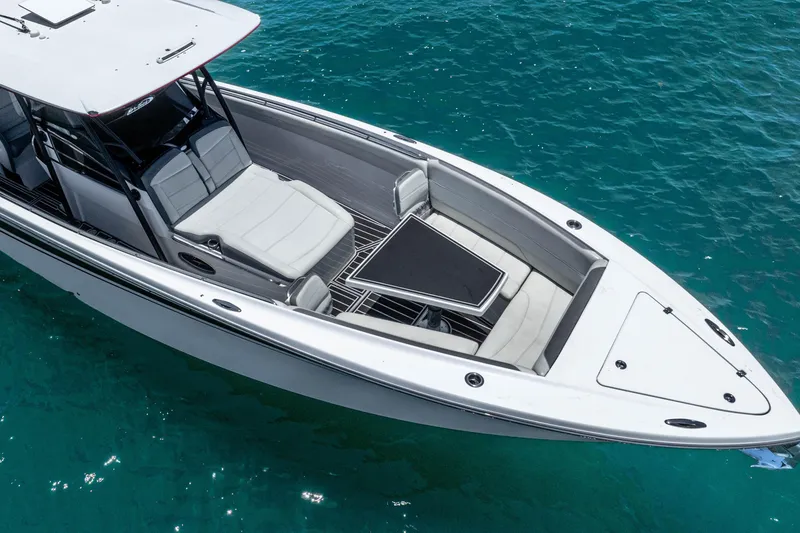 Slide: The Image of 2019 Nor-Tech 390 Sport Center Console boat on clear blue water. - 9