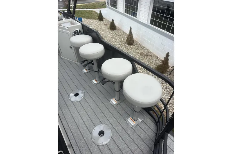 Slide: The Image of Four white bar stools on a 2026 SunChaser Eclipse 25 SBX DH BAR boat deck. - 11