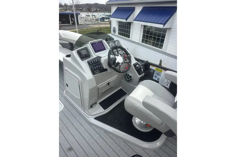 Slide: The Image of Helm of 2026 SunChaser Eclipse 25 SBX DH BAR pontoon boat with modern controls and seating. - 17