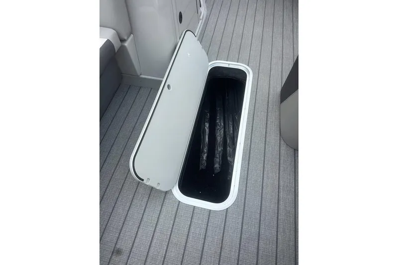 Slide: The Image of Open storage compartment on 2026 SunChaser Eclipse 25 SBX DH BAR boat deck. - 19
