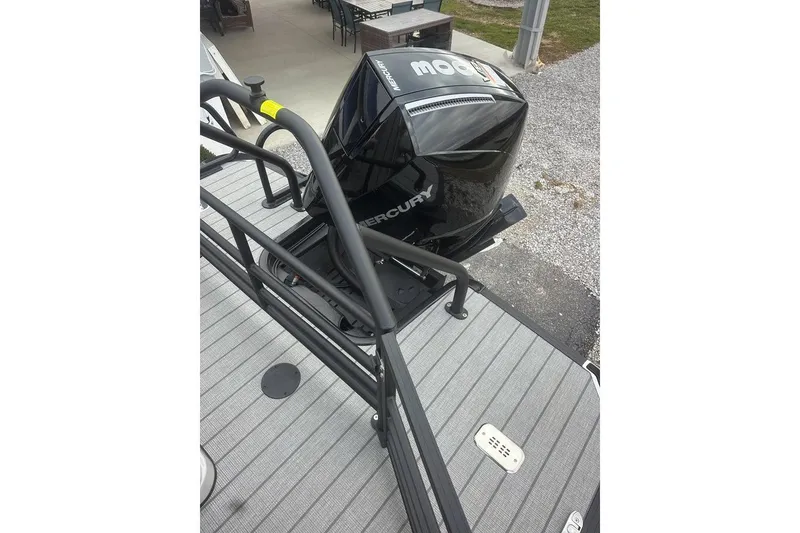 Slide: The Image of 2026 SunChaser Eclipse 25 SBX DH BAR boat with Mercury outboard motor, docked on gray deck. - 4