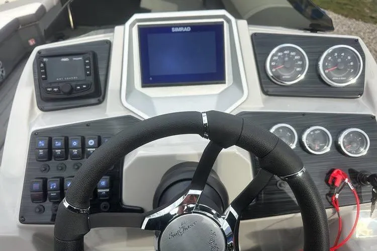 Slide: The Image of 2026 SunChaser Eclipse 25 SBX DH BAR dashboard with steering wheel, gauges, and Simrad display. - 5