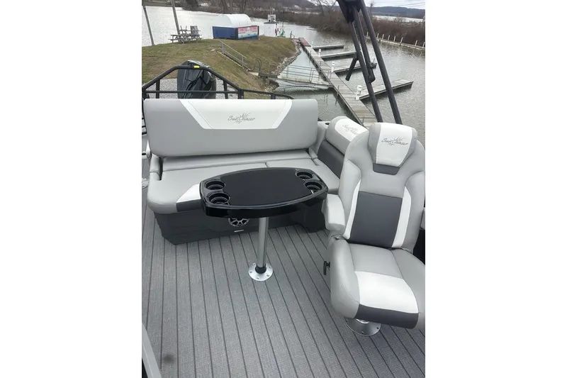 Slide: The Image of 2026 SunChaser Eclipse 25 SBX DH BAR pontoon boat interior with seating and table. - 9