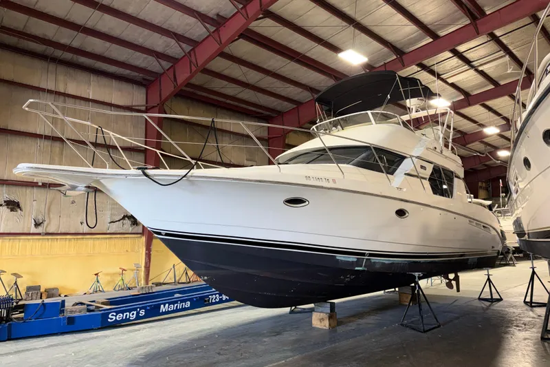 The Image of 2001 Silverton 351 Sedan yacht in marina storage, showcasing sleek design and sturdy construction. - 1