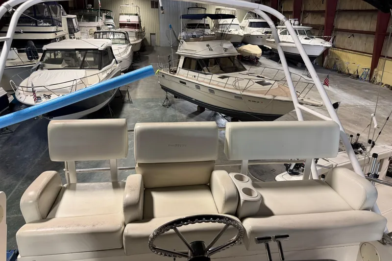 Slide: The Image of 2001 Silverton 351 Sedan in a boat storage facility with multiple yachts. - 10