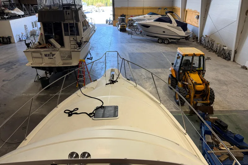 Slide: The Image of 2001 Silverton 351 Sedan in a boat storage facility with other vessels and equipment. - 11