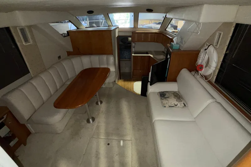 Slide: The Image of Interior of a 2001 Silverton 351 Sedan yacht with seating and kitchenette. - 12
