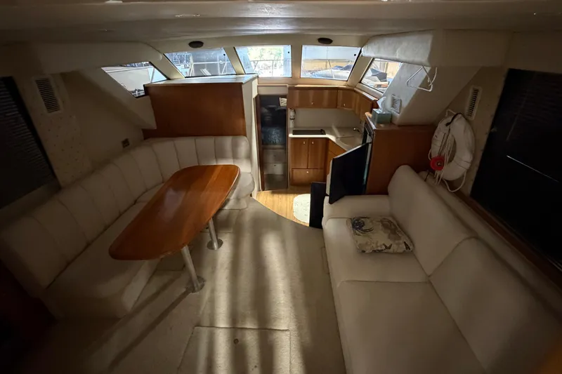 Slide: The Image of Interior of a 2001 Silverton 351 Sedan yacht with cozy seating and kitchenette. - 13