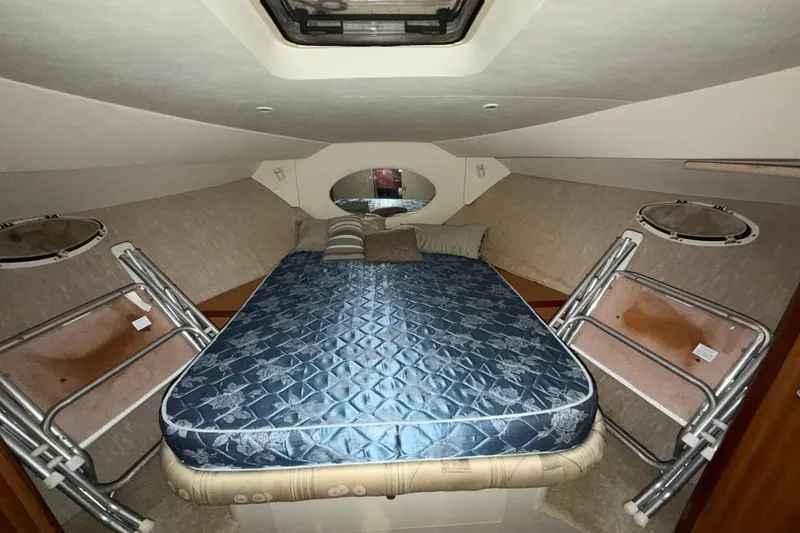 Slide: The Image of 2001 Silverton 351 Sedan cabin interior with bed and portholes. - 15