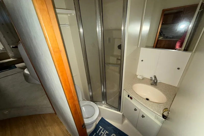 Slide: The Image of 2001 Silverton 351 Sedan bathroom with shower, sink, and toilet in compact layout. - 16