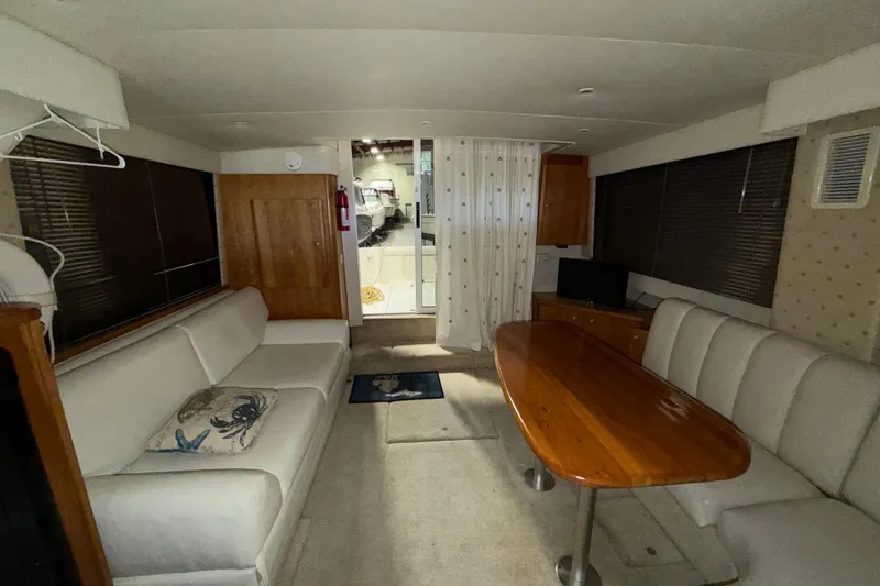 Slide: The Image of Interior of a 2001 Silverton 351 Sedan yacht with cozy seating and wooden table. - 17