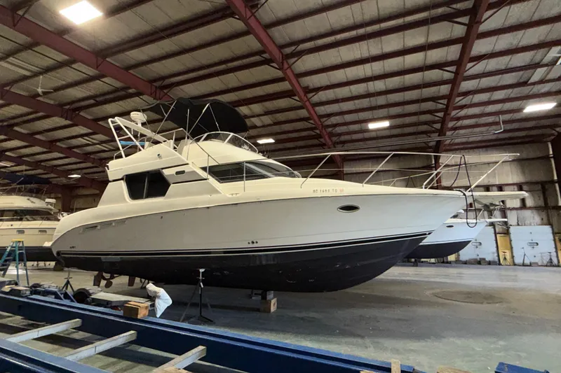 Slide: The Image of 2001 Silverton 351 Sedan yacht in a spacious indoor storage facility. - 3