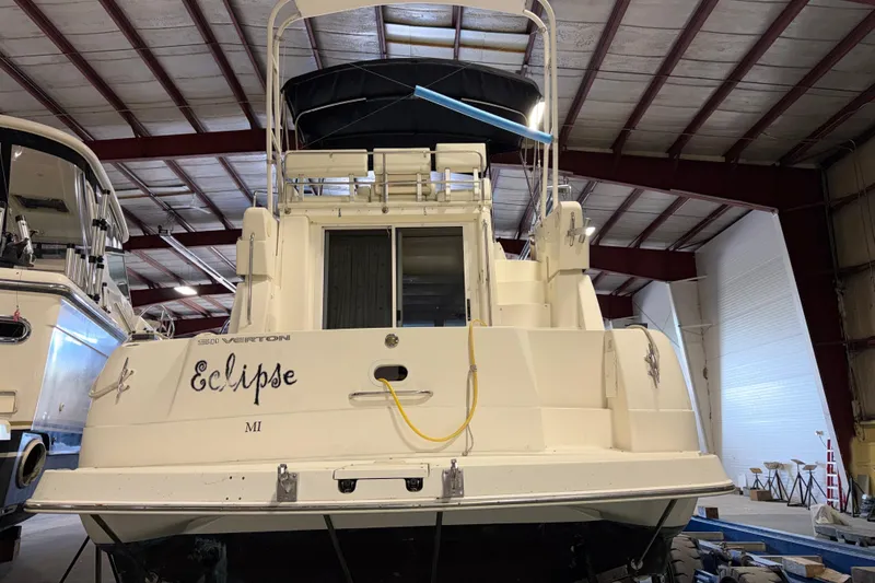 Slide: The Image of 2001 Silverton 351 Sedan boat named "Eclipse" in indoor storage facility. - 4