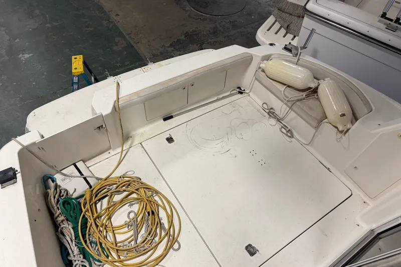 Slide: The Image of 2001 Silverton 351 Sedan boat deck with ropes and fenders in a storage area. - 6