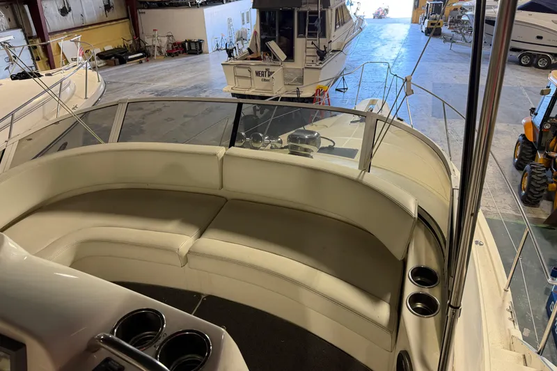 Slide: The Image of 2001 Silverton 351 Sedan yacht interior with white seating in a storage facility. - 9