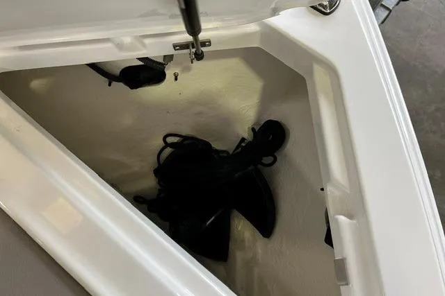 Slide: The Image of Storage compartment of 2024 Cobalt R4 boat with black ropes inside. - 11
