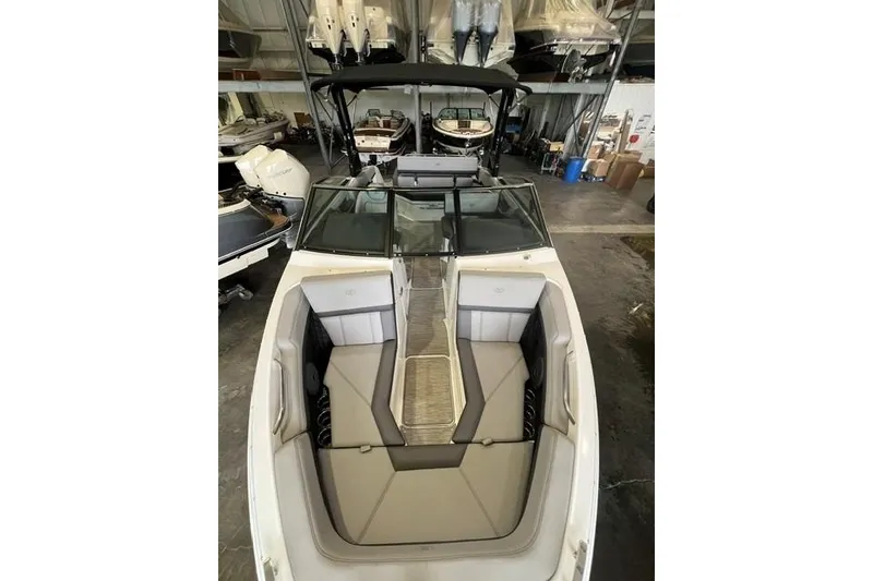 Slide: The Image of 2024 Cobalt R4 boat interior with seating, stored in a warehouse. - 15