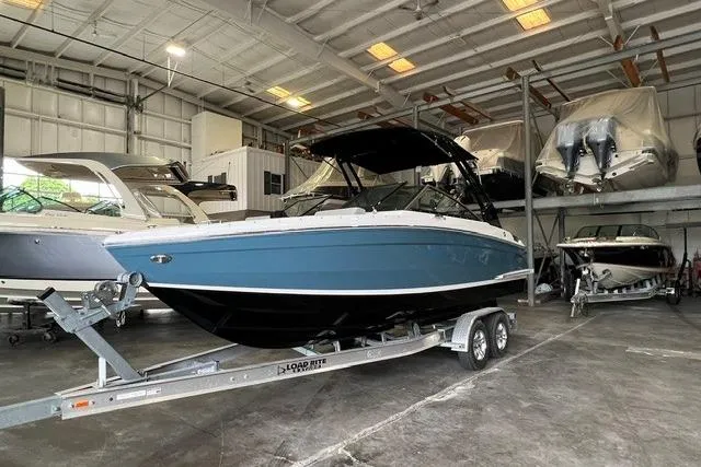 Slide: The Image of 2024 Cobalt R4 boat in storage, blue hull, on trailer, indoor facility. - 3
