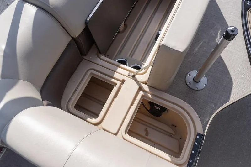 Slide: The Image of 2019 Sun Tracker Fishin' Barge 22 DLX interior storage compartments and seating area. - 13