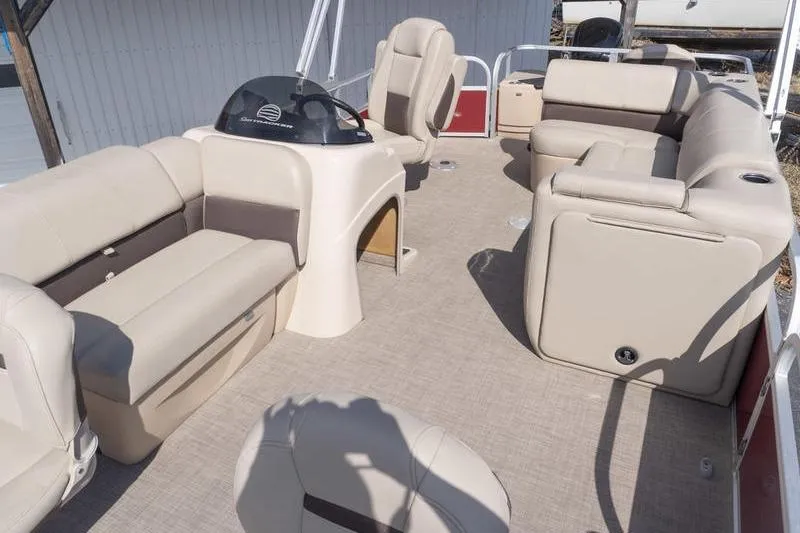 Slide: The Image of 2019 Sun Tracker Fishin' Barge 22 DLX interior with beige seating and helm. - 15