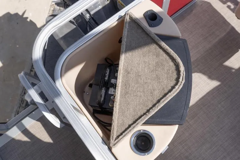 Slide: The Image of 2019 Sun Tracker Fishin' Barge 22 DLX battery compartment with carpeted cover. - 21