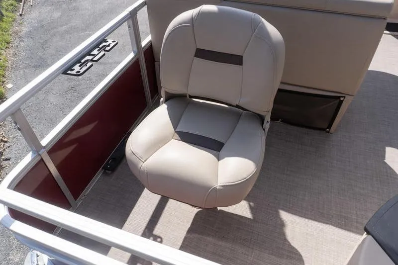 Slide: The Image of 2019 Sun Tracker Fishin' Barge 22 DLX boat seat, beige upholstery, on deck. - 22