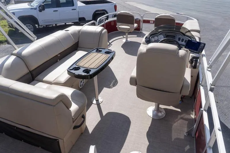Slide: The Image of 2019 Sun Tracker Fishin' Barge 22 DLX interior with seating and steering console. - 6