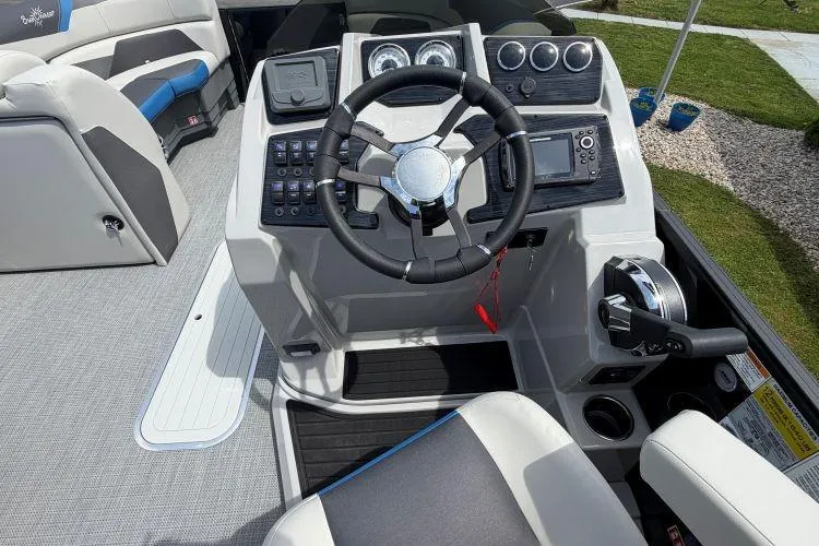 Slide: The Image of 2026 SunChaser Geneva Sport 23 LR DH boat cockpit with modern steering and controls. - 7