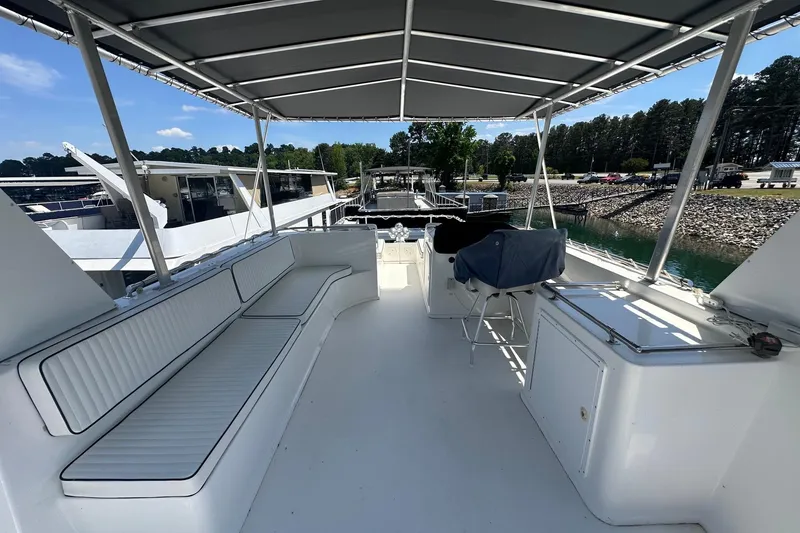 Slide: The Image of Spacious deck of 2007 Fantasy 18x75 houseboat with seating and canopy, docked at marina. - 13