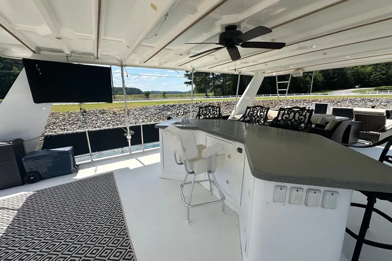 Slide: The Image of Luxurious 2007 Fantasy 18x75 houseboat deck with bar, seating, and ceiling fan. - 16