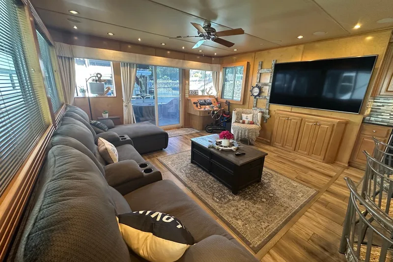 Slide: The Image of Luxurious houseboat interior with cozy seating, large TV, and elegant decor, Fantasy 18x75 model, 2007. - 2