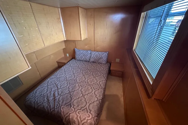 Slide: The Image of Cozy bedroom with wooden paneling, patterned bedding, and a large window with blinds. - 7