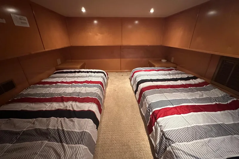 Slide: The Image of Cozy bedroom with twin beds, striped bedding, and warm wood paneling in a 2007 Fantasy 18x75. - 8