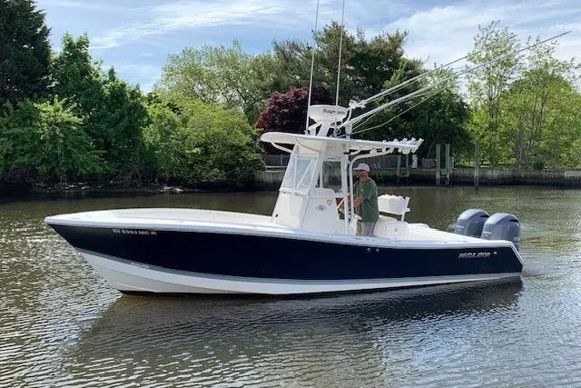 The Image of 2006 Regulator 24 Classic boat on calm water, surrounded by lush greenery. - 0